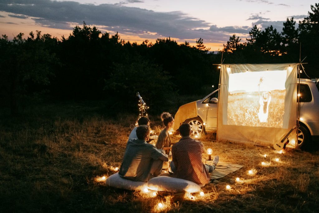 Group of friends enjoying movie night outdoors in nature Bachelor Party